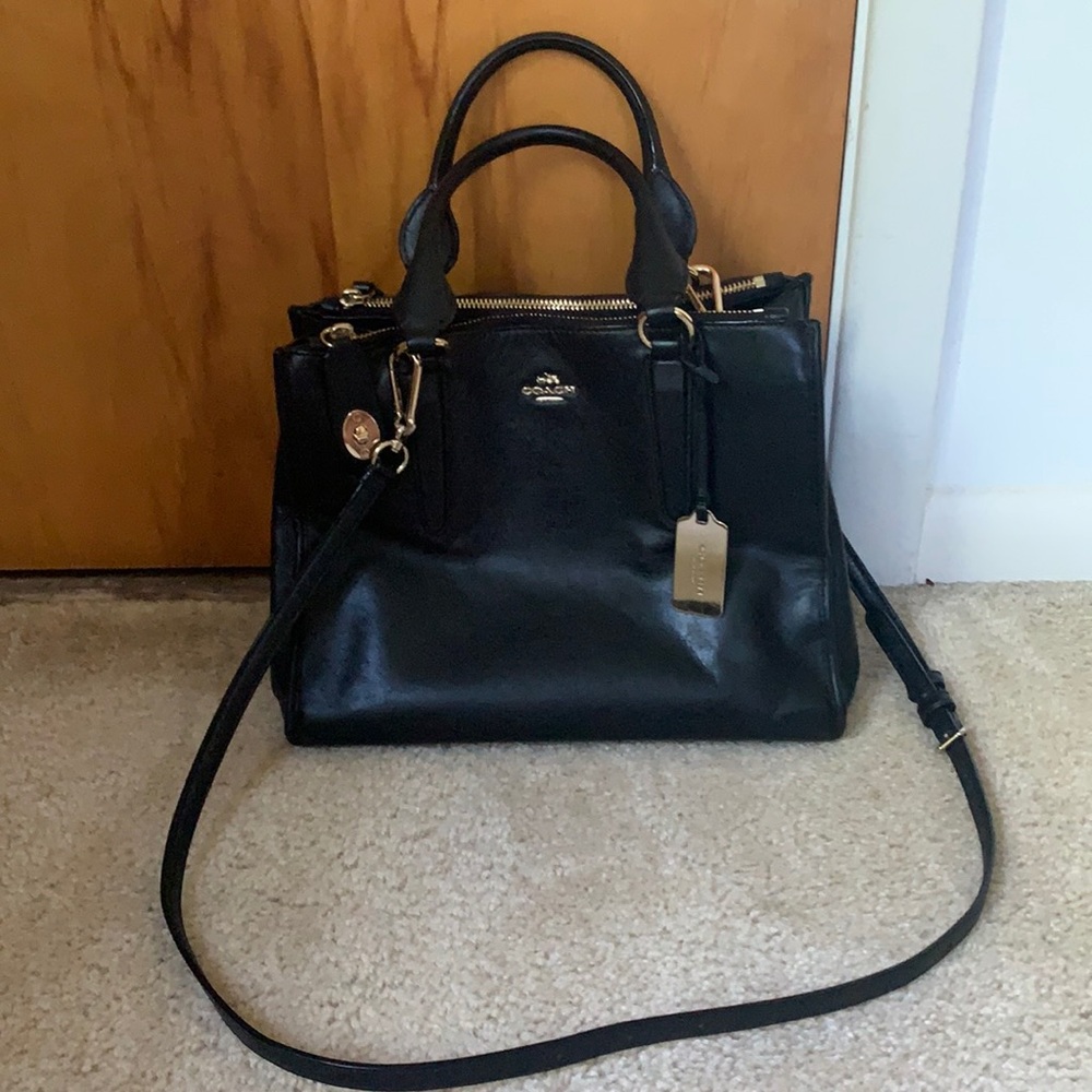 Newer style coach tote with gold hand tag.